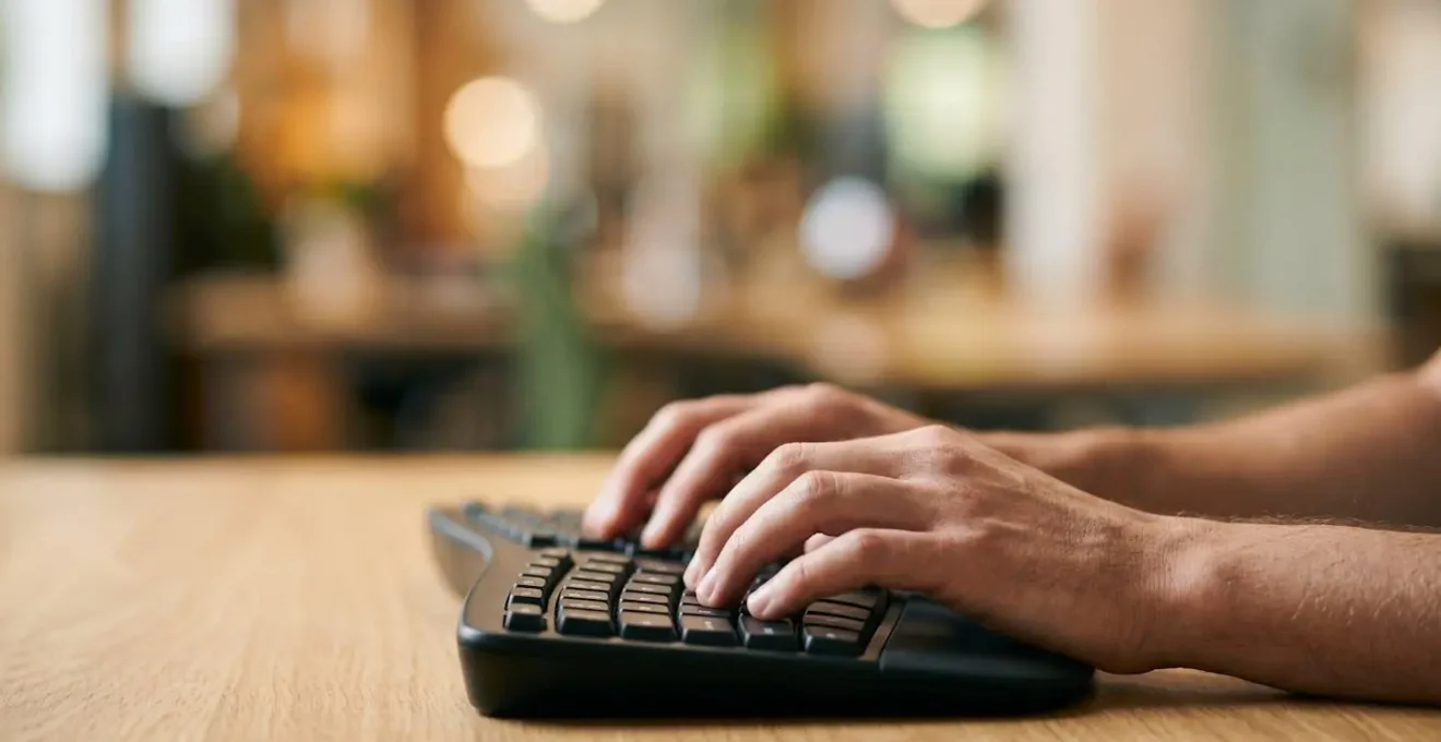 Hands positioned on keyboard demonstrating professional typing posture with dynamic motion blur